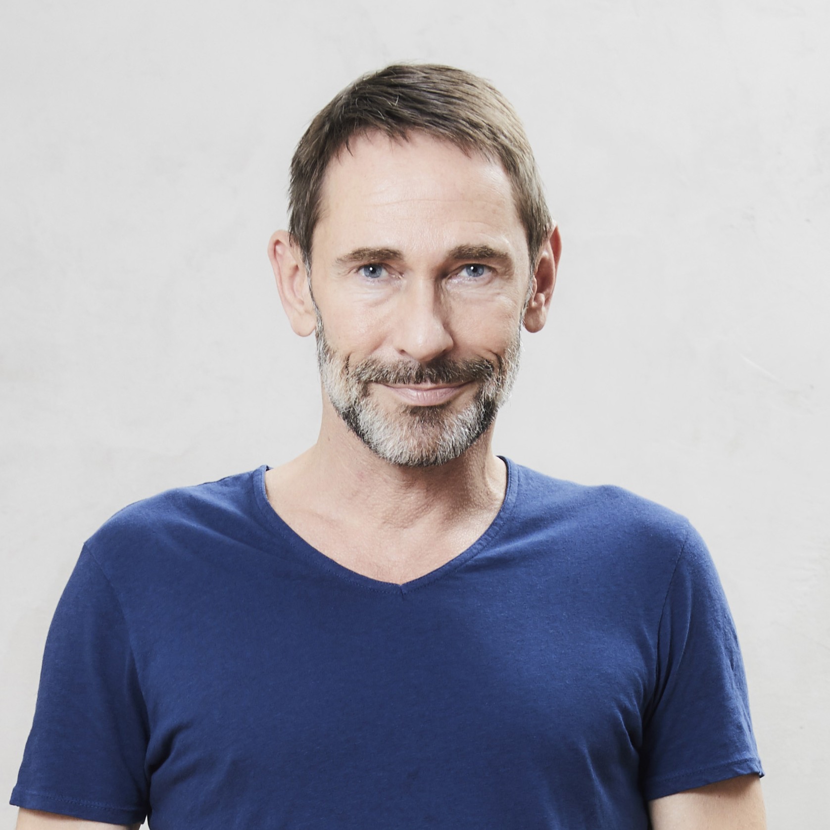 Mature man standing on wooden floor